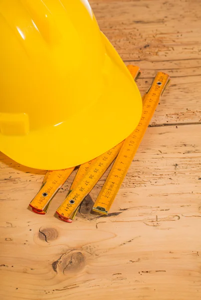 Yellow helmet and measuring tool — Stock Photo, Image