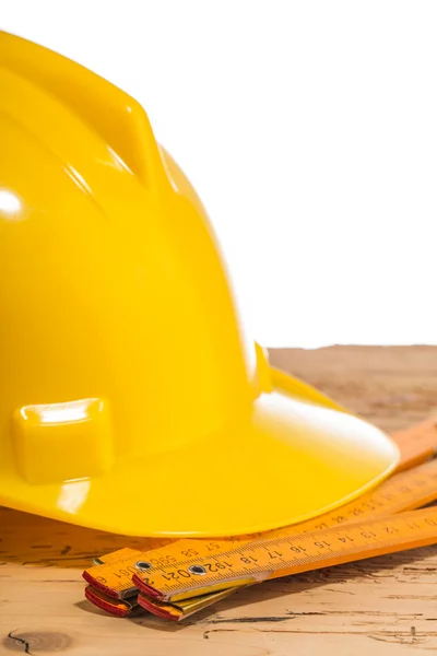 Yellow helmet and measuring tool — Stock Photo, Image