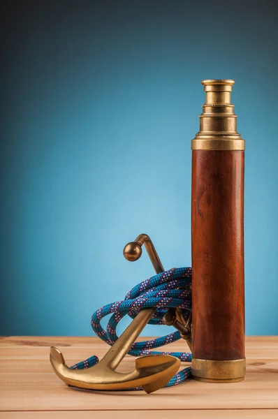 Maritime adventure old anchor and brass telescope — Stock Photo, Image