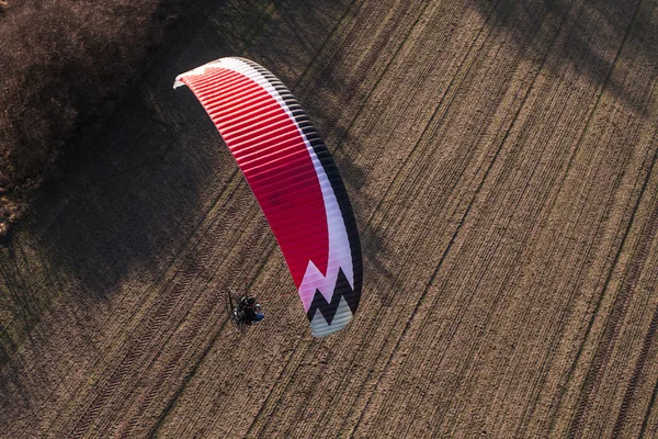 Aerial view of paramotor flying over the harvest field — Stock Photo, Image