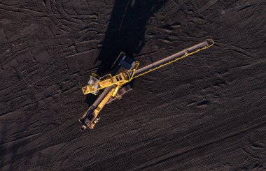 aerial view of moving belt with a heap of coal next to the coal  clipart