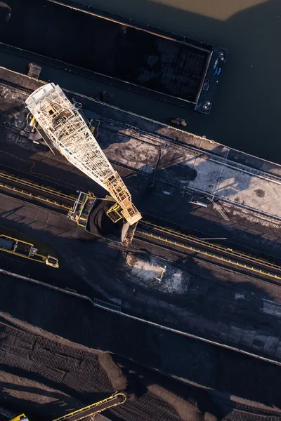 Aerial view of moving crane with a heap of coal next to the coal — Stock Photo, Image