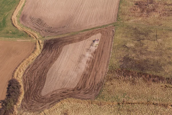 Aerial view of  of tractor on harvest field — Stock Photo, Image