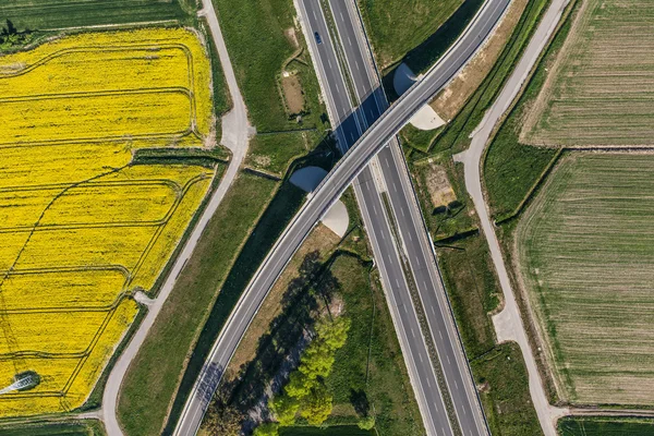 Aerial view of highway and green harvest fields — Stock Photo, Image