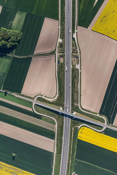 Aerial view of highway and green harvest fields — Stock Photo, Image