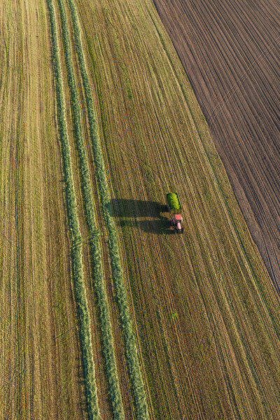 aerial view of harvest fields with combine and tractor 