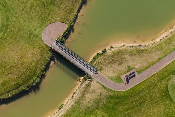 Aerial view over golf field bridge — Stock Photo, Image