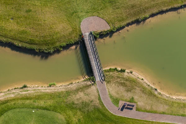 Aerial view over golf field bridge — Stock Photo, Image