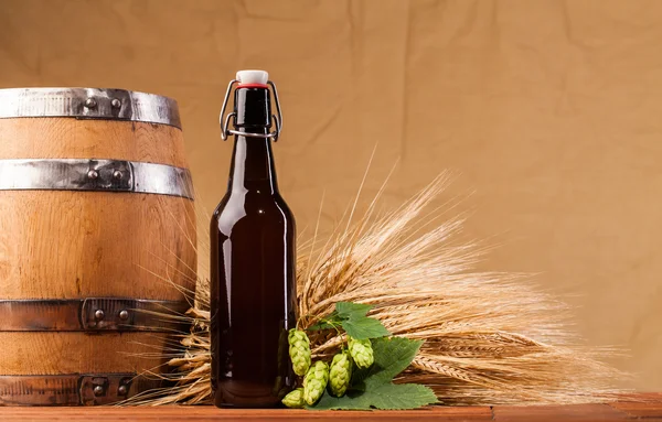 Beer bottle and spikes of barley — Stock Photo, Image