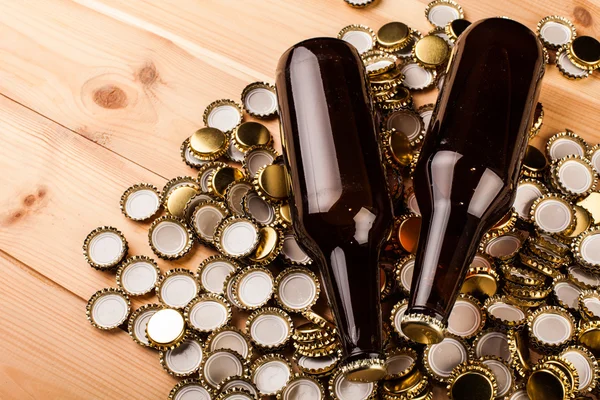 Bottles of homemade beer and caps — Stock Photo, Image