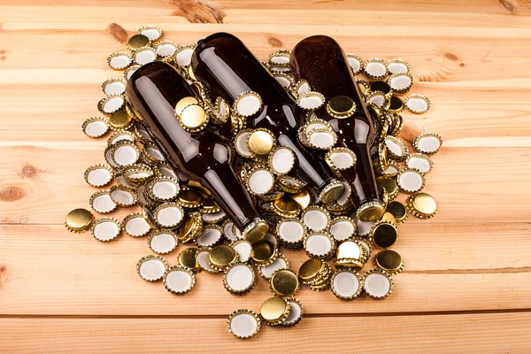 Bottles of homemade beer and caps — Stock Photo, Image