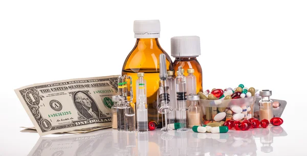 Variety medicines, syringes and dollars — Stock Photo, Image