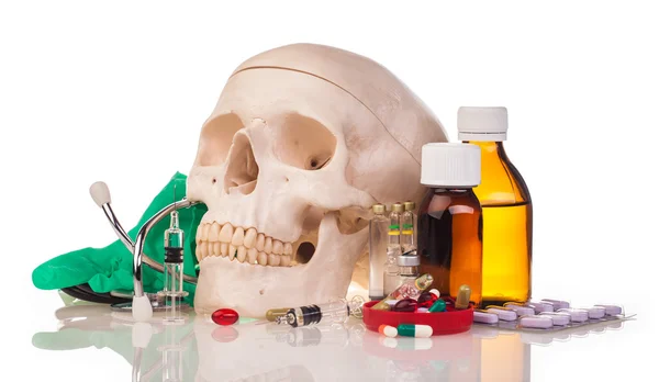 Medicines, human skull and stethoscope — Stock Photo, Image