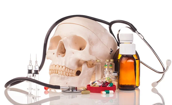 Medicines, human skull and stethoscope — Stock Photo, Image