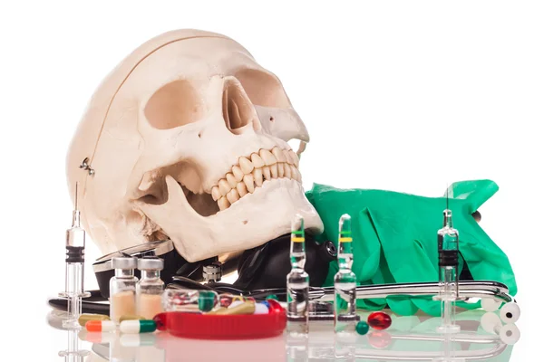 Medicines, human skull and stethoscope — Stock Photo, Image