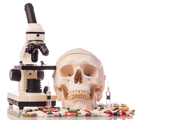 Medicines, microscope and human skull — Stock Photo, Image