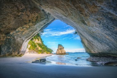view from the cave at cathedral cove beach,coromandel,new zealand clipart