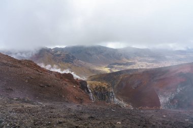 hiking the tongariro alpine crossing on cone volcano mount ngauruhoe in new zealand clipart