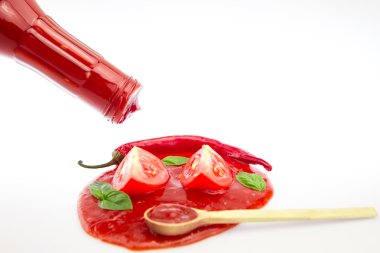 Tomato ketchup in a wooden spoon on a white background. Homemade, healthy vegetarian food