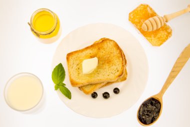 fresh french toast with butter on a white plate with berries on a white background. healthy diet