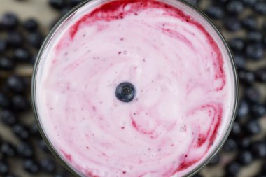 Blueberry smoothie with berries on wooden background. Healthy vegetarian food, diet.