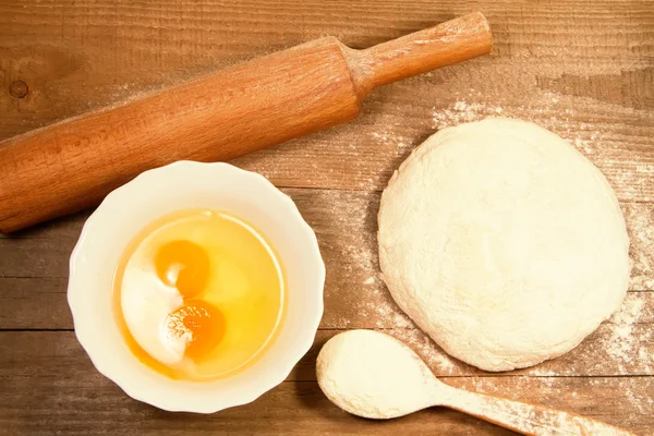 homemade baking. Fresh dough for pastry, kitchen rolling pin, spoon flour, broken eggs on a chopping Board