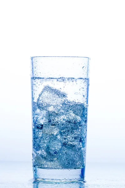 Elegant glass with water and ice on a white background — Stock Photo, Image