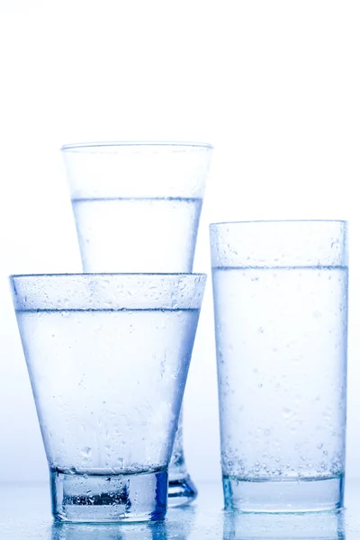 Three elegant glass of water and reflection — Stock Photo, Image