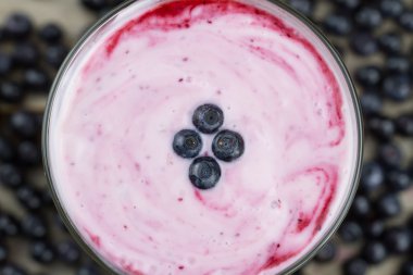 Blueberry smoothie with berries on wooden background. Healthy vegetarian food, diet.