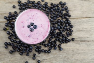 Blueberry smoothie with berries on wooden background. Healthy vegetarian food, diet.