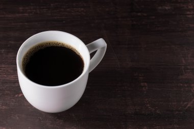 Ahşap masa üzerinde yapılmış siyah kahve fincan