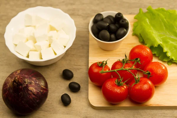 Home cooking summer Greek salad on wooden background — Stock Photo, Image