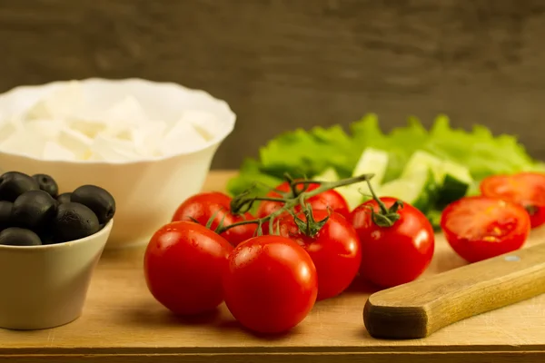 Home cooking summer Greek salad on wooden background — Stock Photo, Image