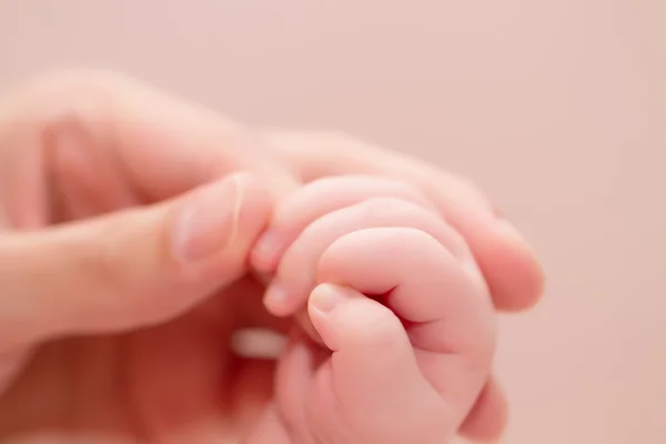 Concepto de amor y familia. Manos de madre y bebé —  Fotos de Stock