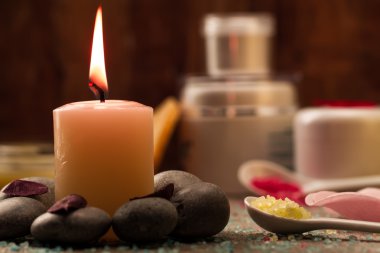Spa composition with sea salt, candles, soap, shells, creams for face on wooden background. Aromatherapy.