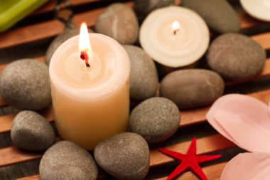 Spa composition with sea salt, candles, soap, shells, creams for face on wooden background. Aromatherapy.
