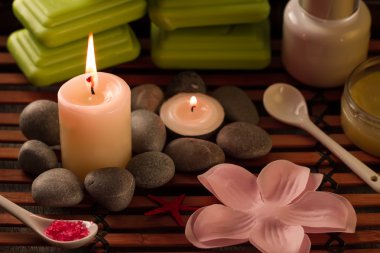 Spa composition with sea salt, candles, soap, shells, creams for face on wooden background. Aromatherapy.