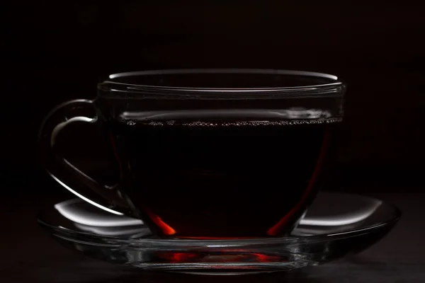 The black Cup of hot tea on wooden table — Stock Photo, Image