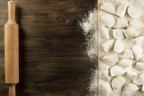 Homemade pasta ravioli over wooden table with flour. kitchen utensils — 스톡 사진