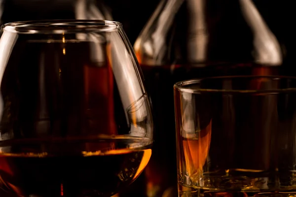 Bardak buz ve ahşap bir masa üzerinde bir şişe viski. Konyak, brandy. — Stok fotoğraf