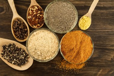 Wooden table with colorful spices, herbs and vegetables.  Asian cuisine