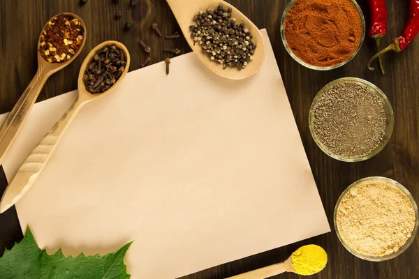 Sheet old vintage paper with spices on wooden background. Healthy vegetarian food. Recipe, menu, mock up, cooking. — 스톡 사진