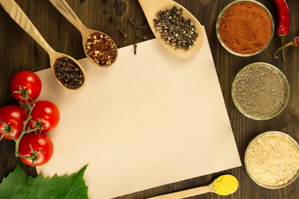 sheet old vintage paper with spices on wooden background. Healthy vegetarian food. Recipe, menu, mock up, cooking.
