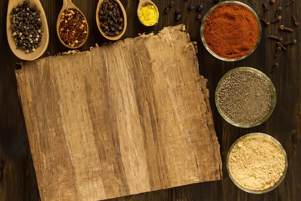 Sheet old vintage paper with spices on wooden background. Healthy vegetarian food. Recipe, menu, mock up, cooking. — 스톡 사진
