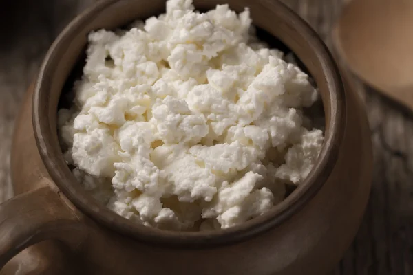 Fresh tasty curd in pot on wooden background. Homemade, cottage cheese — Stock Photo, Image