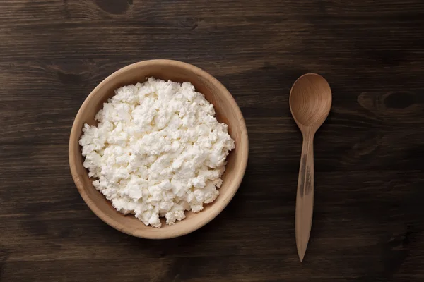 Fresh tasty curd in pot on wooden background. Homemade, cottage cheese — Stock Photo, Image