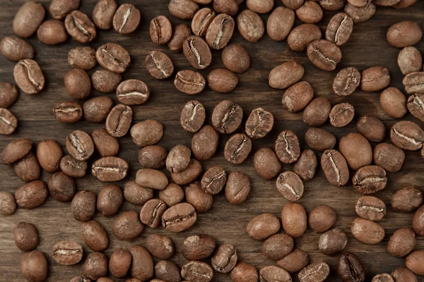 Hintergrund-Kaffee. geröstete Bohnen auf altem Holzgrund — Stockfoto