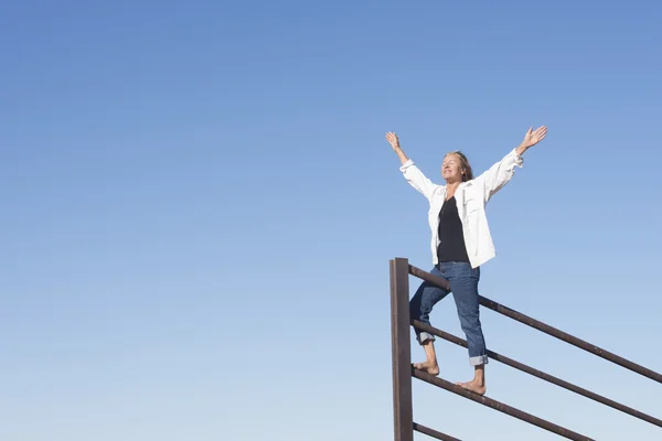 Happy joyful woman with arms up outdoor — Stock Photo, Image