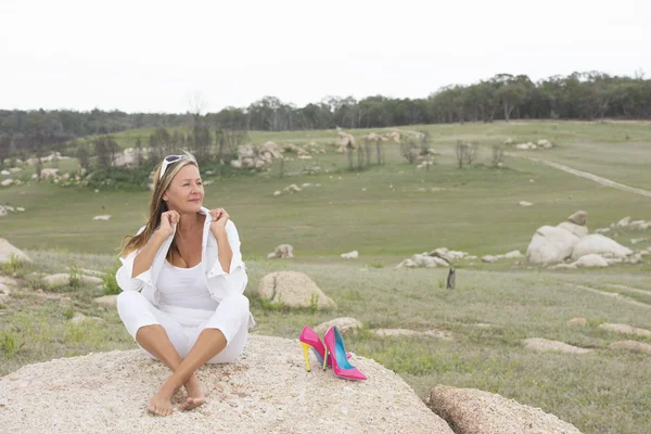 Happy relaxed woman outdoor with high heels — Stock Photo, Image