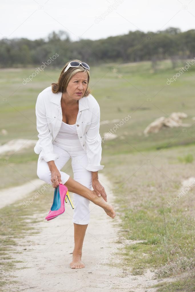 Suffering woman in high heels with sore feet Stock Photo by ©roboriginal 56445195